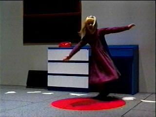 Girl spins on red rug